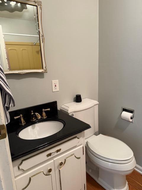 1337 Stratford Dr, Piqua, OH 45356 - bathroom with vanity, toilet, wood finished floors, and a shower with curtain
