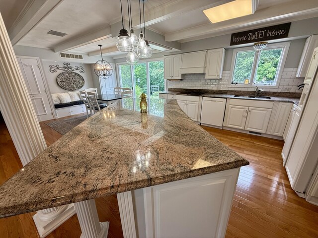 1337 Stratford Dr, Piqua, OH 45356 - kitchen with dishwasher, a sink, tasteful backsplash, white cabinetry, and dark stone counters