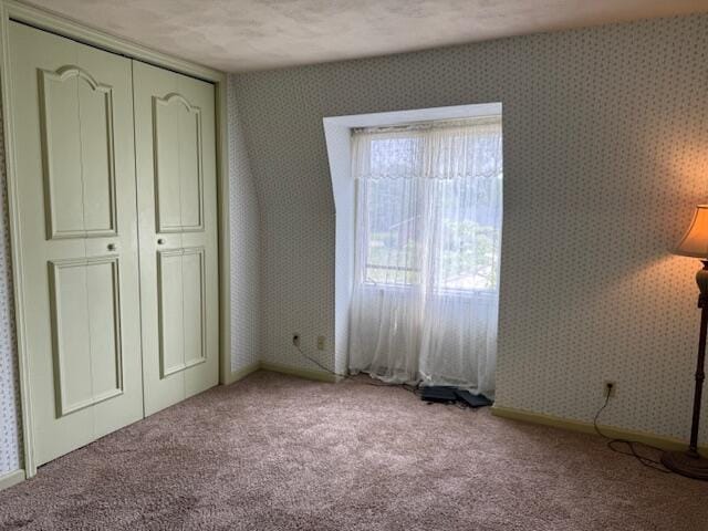 1337 Stratford Dr, Piqua, OH 45356 - unfurnished bedroom with carpet flooring, wallpapered walls, and a closet