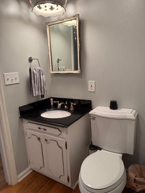 1337 Stratford Dr, Piqua, OH 45356 - half bath featuring vanity, wood finished floors, and toilet
