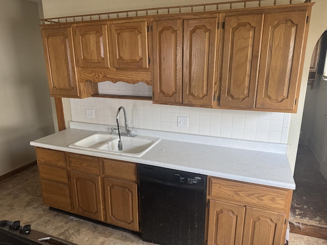 1108 N Fountain Blvd, Springfield, OH 45504 - kitchen featuring dishwasher, backsplash, light countertops, and brown cabinetry