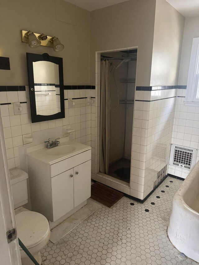 1108 N Fountain Blvd, Springfield, OH 45504 - full bath featuring tile walls, a wainscoted wall, a stall shower, vanity, and tile patterned floors