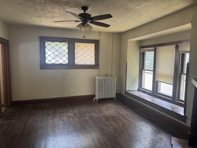 1108 N Fountain Blvd, Springfield, OH 45504 - spare room featuring radiator heating unit, dark wood-type flooring, a textured ceiling, and ceiling fan