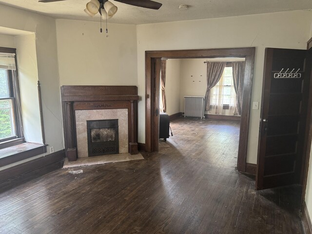 1108 N Fountain Blvd, Springfield, OH 45504 - unfurnished living room featuring radiator, hardwood / wood-style floors, healthy amount of natural light, and a ceiling fan