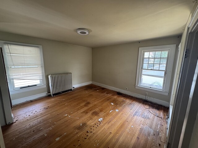 1108 N Fountain Blvd, Springfield, OH 45504 - empty room featuring radiator heating unit and hardwood / wood-style floors