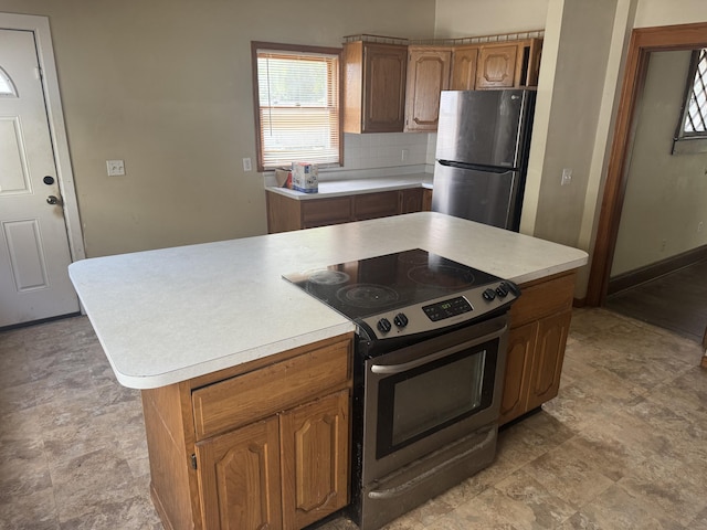 1108 N Fountain Blvd, Springfield, OH 45504 - kitchen featuring stainless steel appliances, light countertops, decorative backsplash, and stone finish flooring