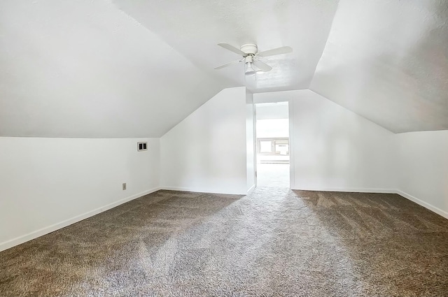 bonus room featuring carpet floors, lofted ceiling, visible vents, ceiling fan, and baseboards