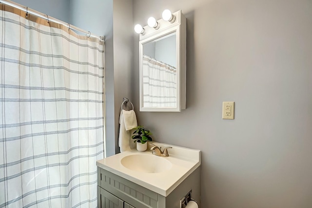 bathroom with curtained shower and vanity