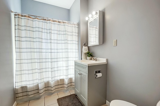 bathroom with toilet, curtained shower, tile patterned flooring, and vanity