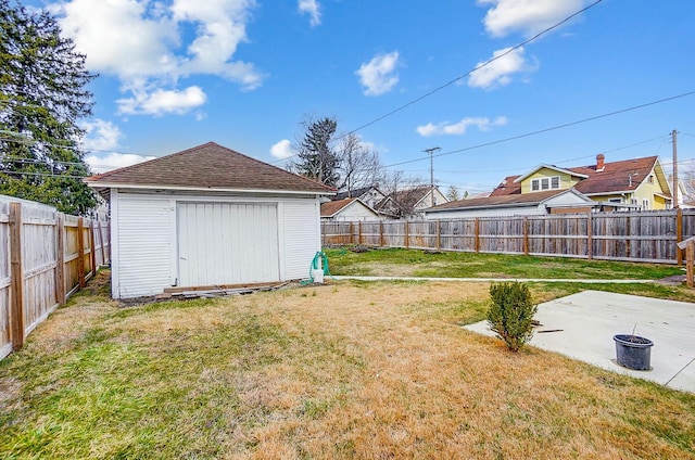 view of yard with a fenced backyard, a patio, an outdoor structure, and a storage shed