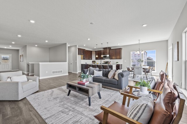 1304 Township Rd Unit 179, Bellefontaine, OH 43311 - living room featuring recessed lighting, baseboards, a textured ceiling, and dark wood finished floors
