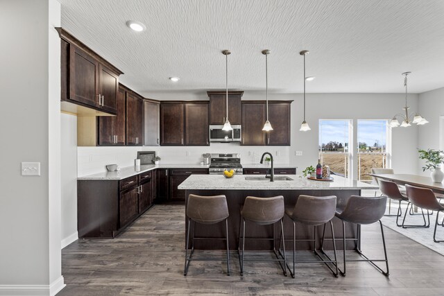 1304 Township Rd Unit 179, Bellefontaine, OH 43311 - kitchen featuring a sink, tasteful backsplash, open floor plan, appliances with stainless steel finishes, and dark wood-style flooring