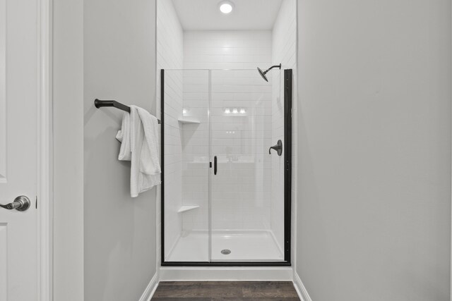 1304 Township Rd Unit 179, Bellefontaine, OH 43311 - bathroom featuring baseboards, wood finished floors, and a stall shower