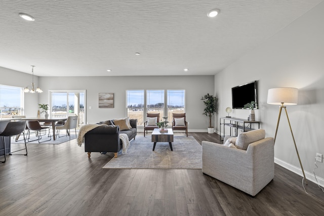1304 Township Rd Unit 179, Bellefontaine, OH 43311 - living area with dark wood-type flooring, a textured ceiling, recessed lighting, baseboards, and a chandelier