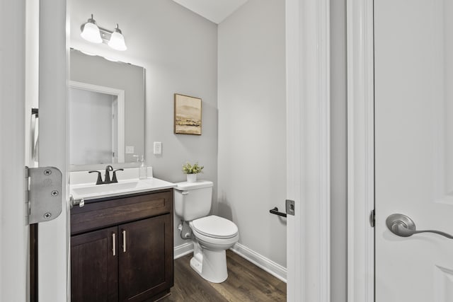1304 Township Rd Unit 179, Bellefontaine, OH 43311 - bathroom with vanity, toilet, wood finished floors, and baseboards