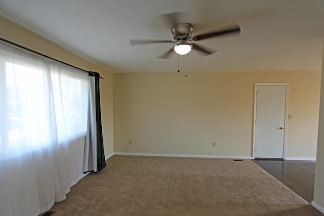 unfurnished room with light tile patterned floors and ceiling fan