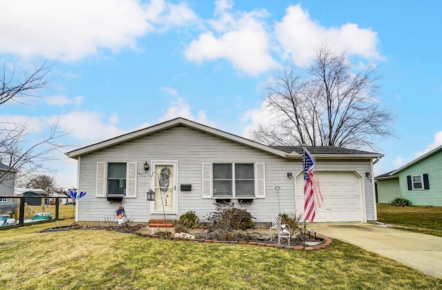 ranch-style house featuring an attached garage, driveway, and a front yard