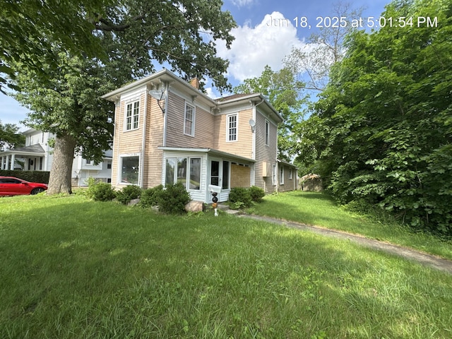 542 N Main St, Ada, OH 45810 - italianate home with a chimney, a front yard, and entry steps