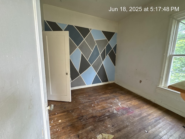 542 N Main St, Ada, OH 45810 - spare room with wood-type flooring and baseboards
