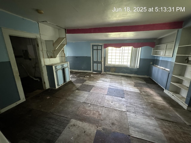 542 N Main St, Ada, OH 45810 - unfurnished living room with baseboards