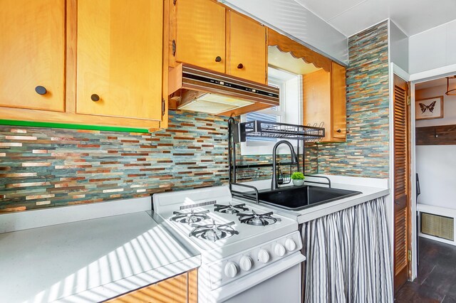 7748 Walnut St, Russells Point, OH 43348 - kitchen with visible vents, a sink, light countertops, under cabinet range hood, and white gas range