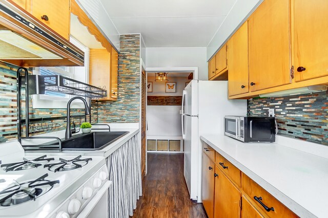 7748 Walnut St, Russells Point, OH 43348 - kitchen featuring white appliances, light countertops, dark wood-type flooring, and backsplash