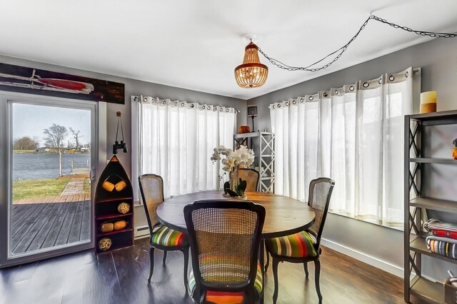 7748 Walnut St, Russells Point, OH 43348 - dining area with wood finished floors, baseboards, and baseboard heating