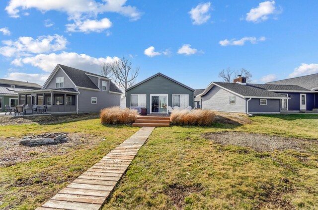 7748 Walnut St, Russells Point, OH 43348 - view of front of property featuring a front lawn, a sunroom, and a wooden deck