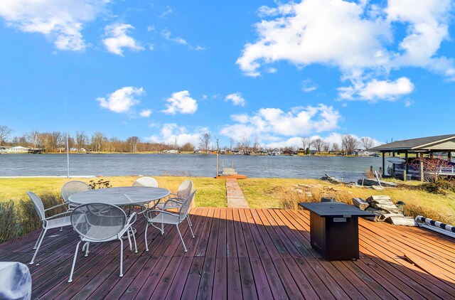 7748 Walnut St, Russells Point, OH 43348 - dock area with outdoor dining space, a deck with water view, and a yard