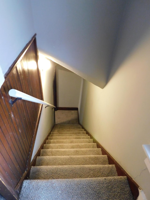 stairway featuring lofted ceiling