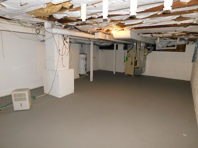 basement featuring heating unit and water heater