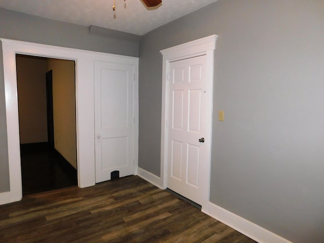 unfurnished bedroom with dark hardwood / wood-style floors