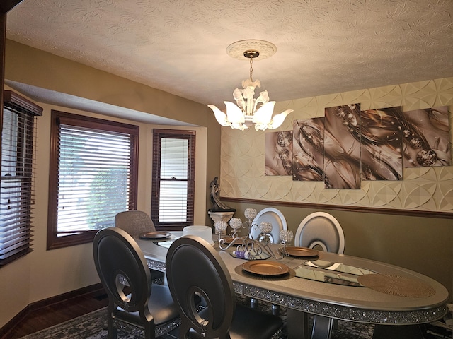 1308 Stonyridge Ave, Troy, OH 45373 - dining area featuring a chandelier, dark wood-style floors, and a textured ceiling