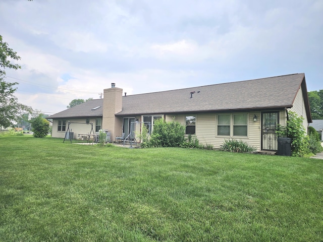1308 Stonyridge Ave, Troy, OH 45373 - back of house with a lawn, a chimney, and roof with shingles