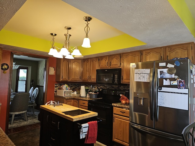 1308 Stonyridge Ave, Troy, OH 45373 - kitchen with black appliances, butcher block counters, tasteful backsplash, brown cabinetry, and vaulted ceiling