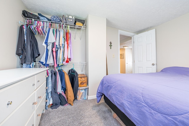 carpeted bedroom featuring a textured ceiling