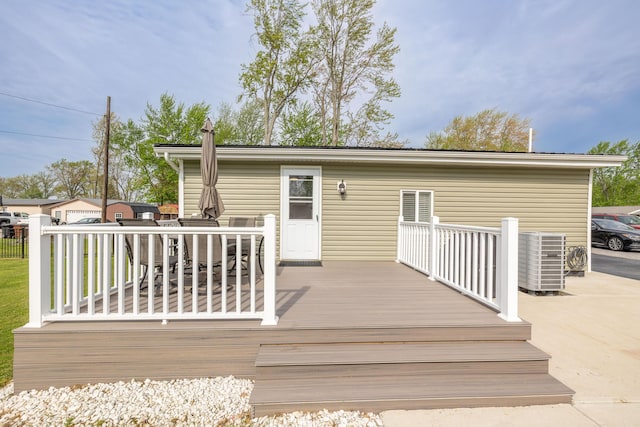 back of property featuring central AC unit, outdoor dining space, and a wooden deck