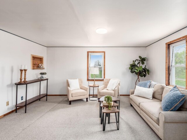 carpeted living area with baseboards