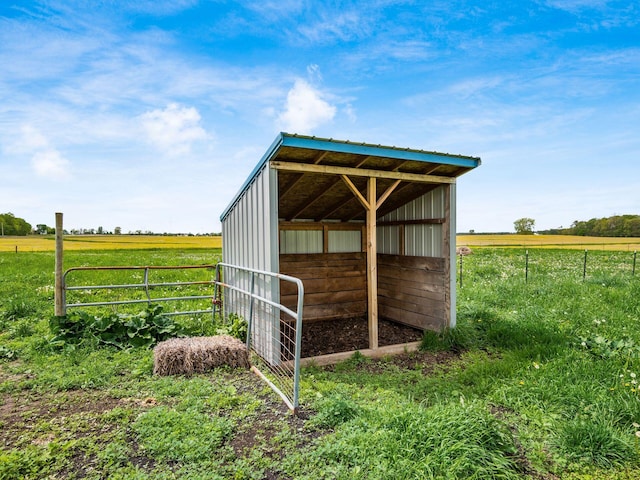 view of pole building with a view of rural / pastoral area and fence
