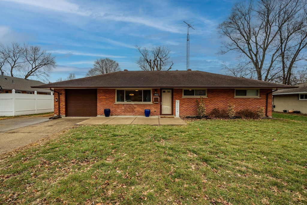 single story home with a garage and a front yard