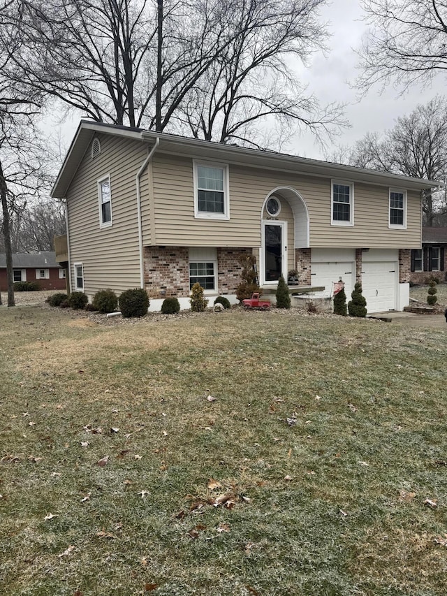 raised ranch with a garage and a front lawn