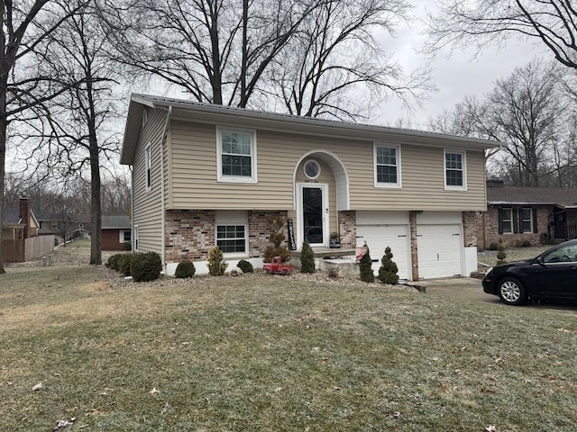 split foyer home featuring a garage and a front lawn