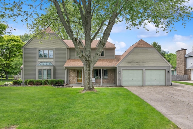 1019 Meadow Lark Dr, Enon, OH 45323 - victorian-style house featuring an attached garage, concrete driveway, a shingled roof, and brick siding