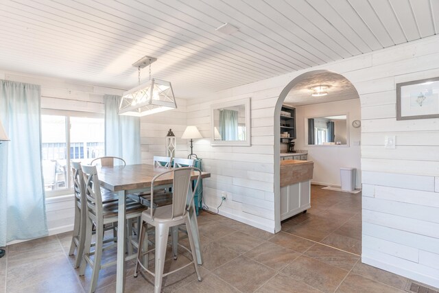 8886 State Route 368, Huntsville, OH 43324 - dining space with wooden walls and arched walkways