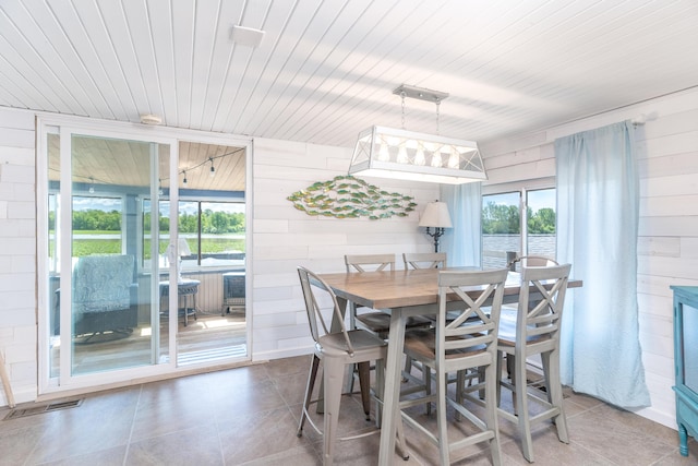 8886 State Route 368, Huntsville, OH 43324 - tiled dining space with wood walls, healthy amount of natural light, and wood ceiling