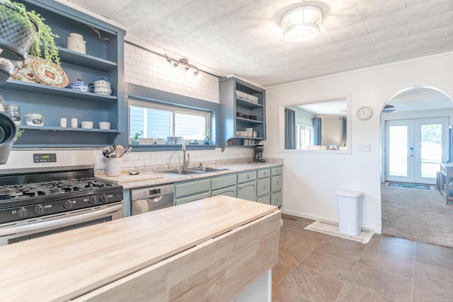 8886 State Route 368, Huntsville, OH 43324 - kitchen with appliances with stainless steel finishes, open shelves, a sink, french doors, and plenty of natural light