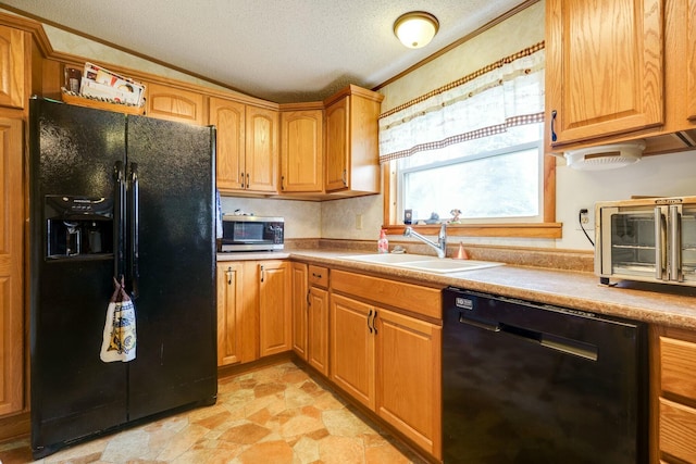 kitchen featuring stone finish flooring, crown molding, a textured ceiling, black appliances, and a sink