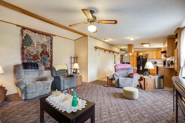 living room featuring a ceiling fan, carpet, crown molding, and a textured ceiling