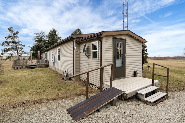 view of property exterior with a yard and a wooden deck