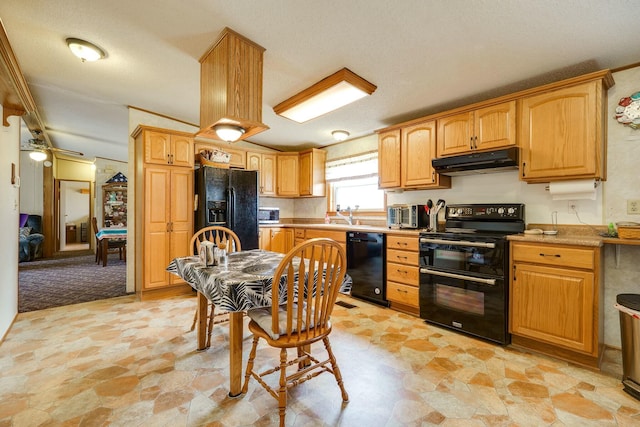 kitchen featuring stone finish floor, light countertops, under cabinet range hood, and black appliances